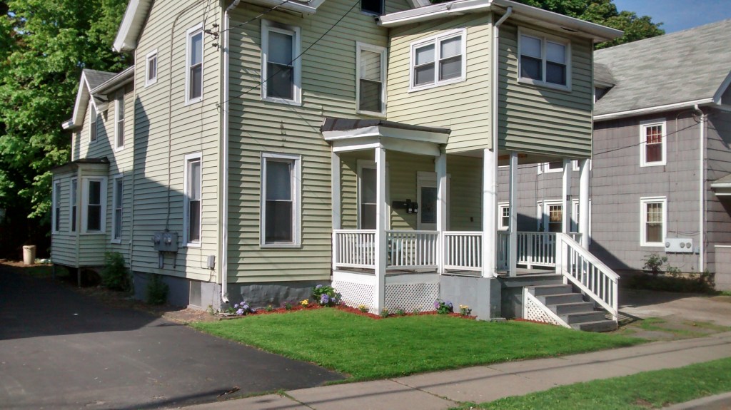 green house with porch and flower and mulch