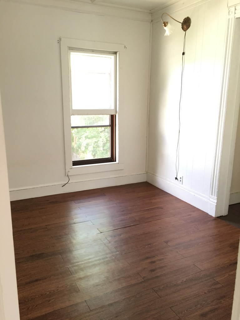bedroom with wood floor and window