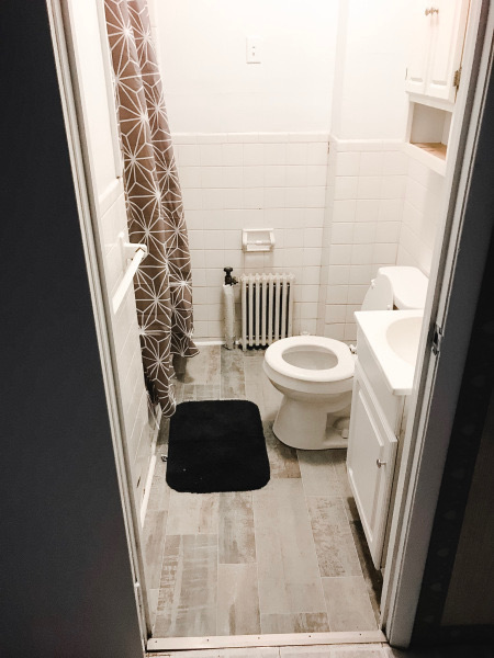 bathroom with toilet and sink as well as heater