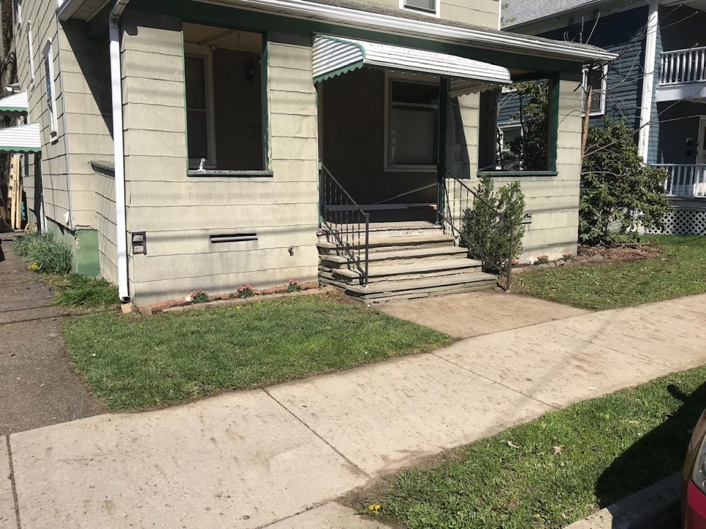 green house with porch and steps to porche