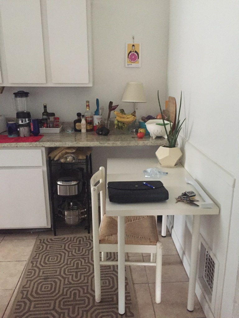 desk next two counter top with mulitple items