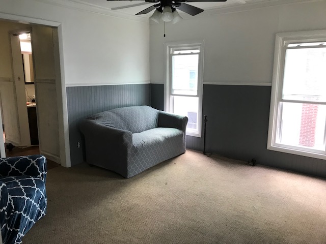 livingroom with two tone gray and white with gray sofa and blue chair