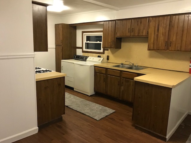 kitchen with cabinets, washer, dryer and sink