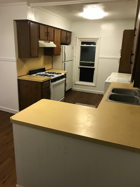 kitchen with stove, cabinets and window