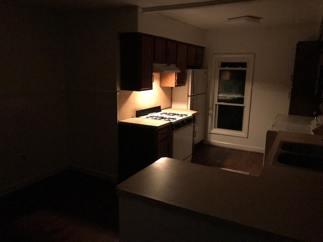 kitchen at night with light on above stove