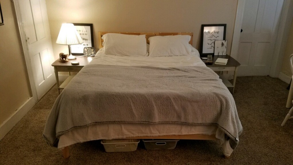 bed with two side tables and two doors for closet