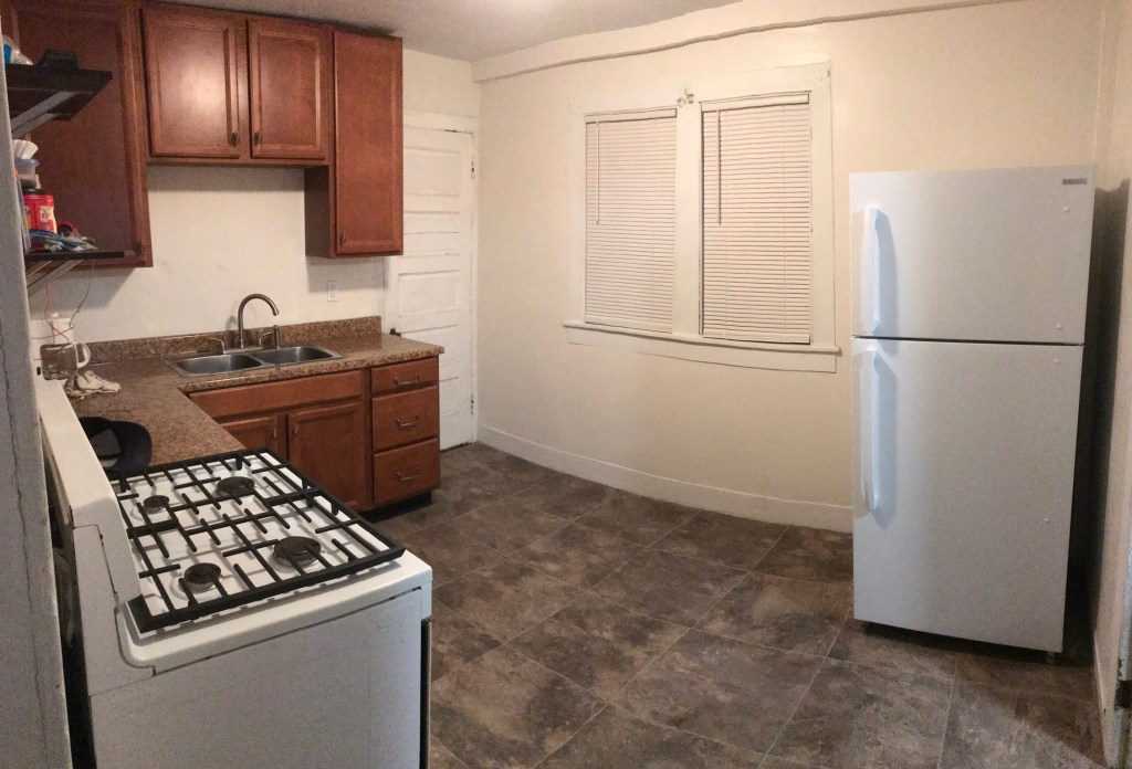 Kitchen with refrigerator and stove and sink