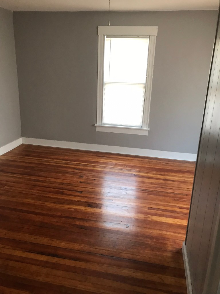 room with window and hardwood flooring