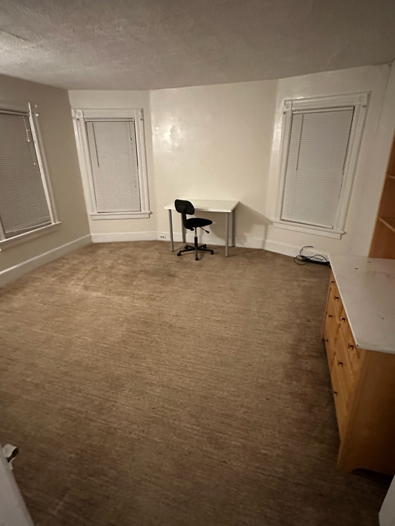 bedroom with dresser and desk with chair