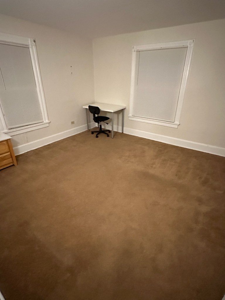 Bedroom with dresser and desk with chair